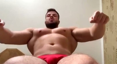Evan Hoti Flexing and Posing In Red Posing Trunks