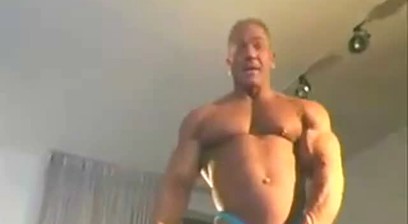Dan Steele Stripping Out Of Blue Posing Trunks and Jacking Off